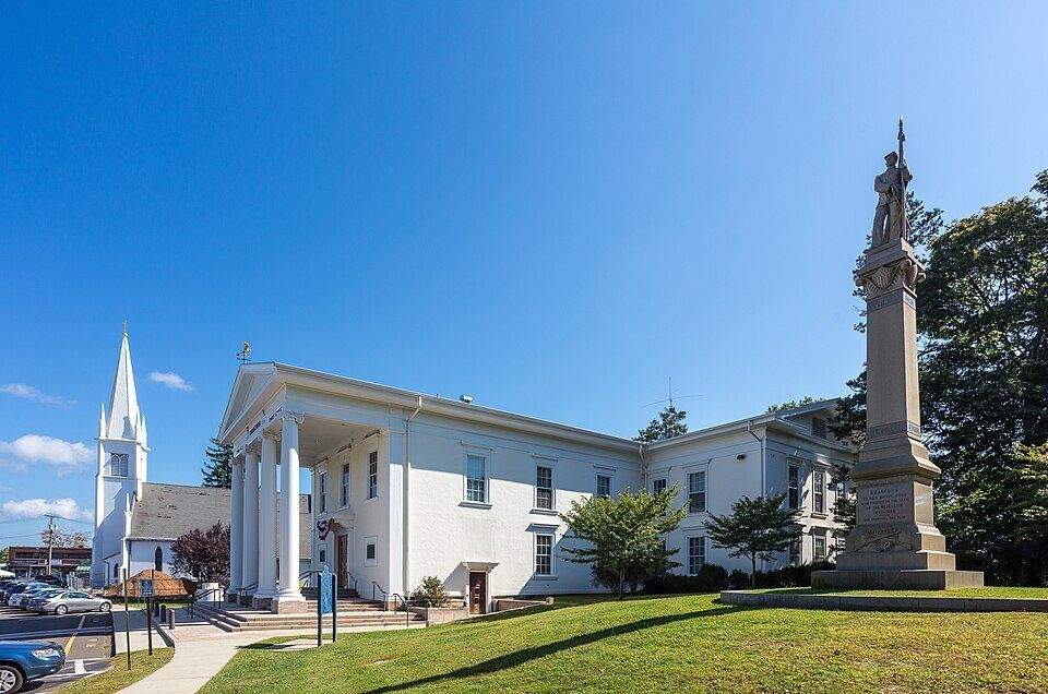 Branford Town Hall with columned portico and Civil War monument on the green
