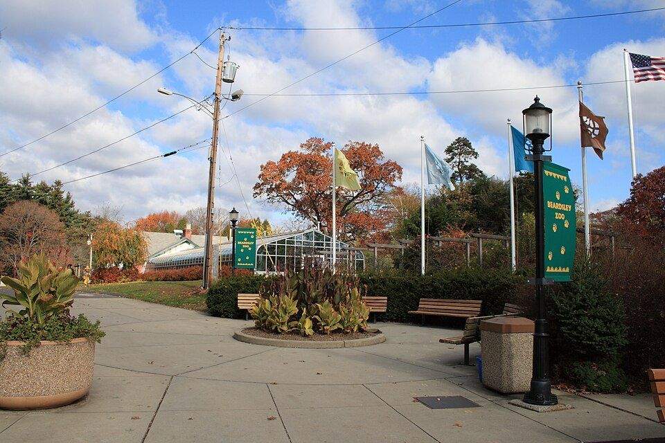 Entrance to Beardsley Zoo in Bridgeport, CT with autumn foliage and banners