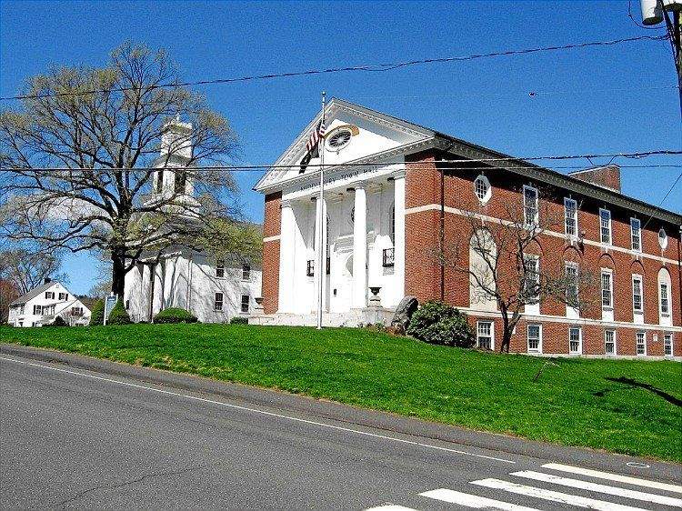 Middlebury Town Hall and Congregational Church with American flag on a spring day