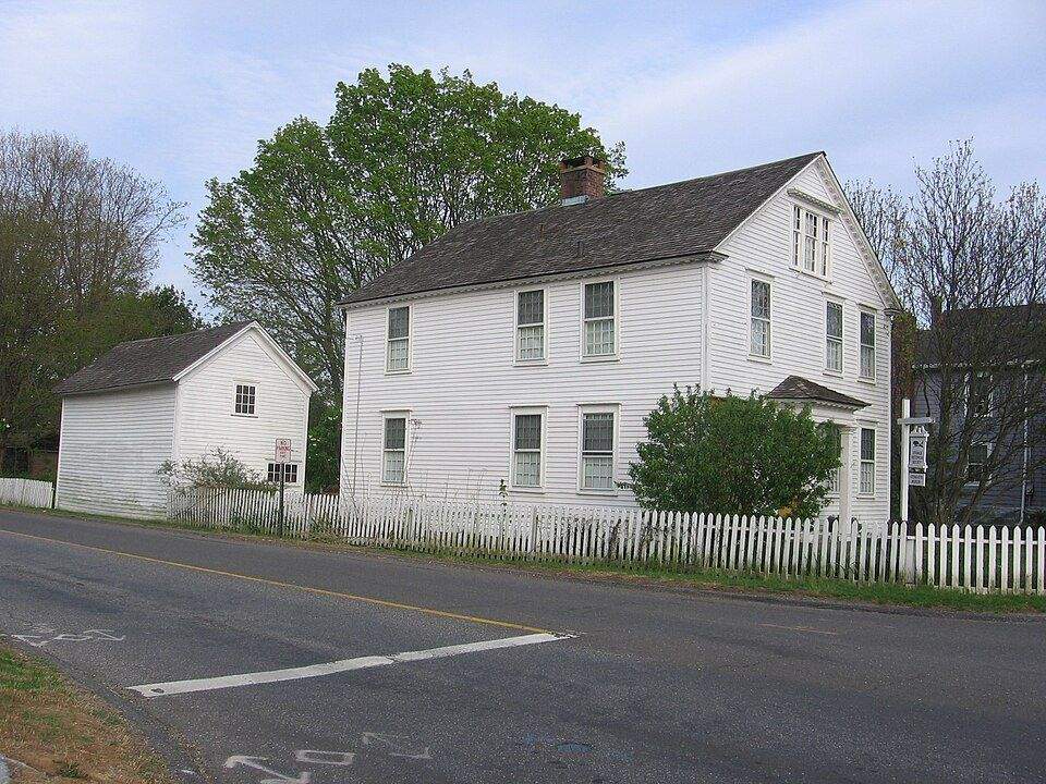 Historic white colonial house with picket fence on Orange Center Road, Orange CT