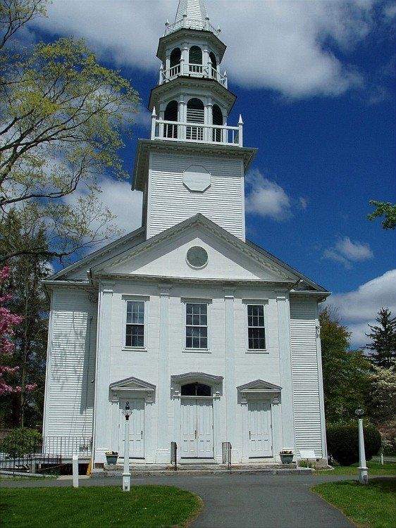 Historic white Congregational Church with tall steeple in Southbury, CT